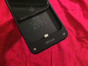 ARCAM MusicBOOST with iPhone partially inserted, showing Lighting connector that mates the devices.